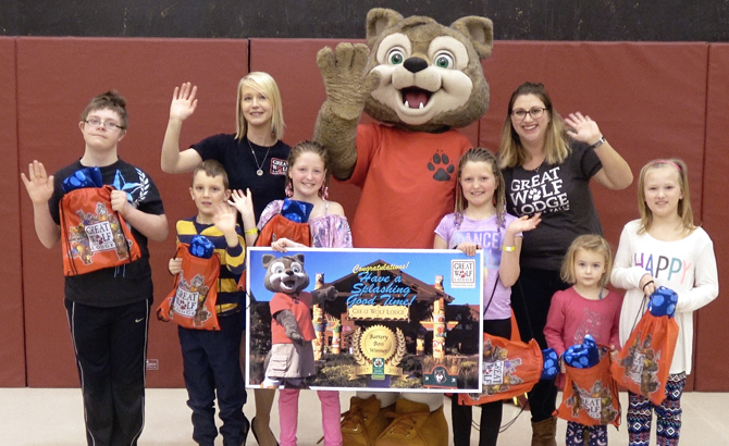 Sarah Lacharity of Raw Materials Company along with Wiley the Wolf pose for a picture with the six Battery Bosses from Montgomery Village Public School. Pictured from left to right; Darby, Ryder, Jillian, Jordan, Claudia and Anika.